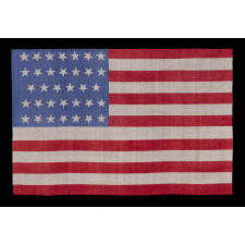 34 STARS ON AN ANTIQUE AMERICAN FLAG, PRINTED ON SILK, WITH "DANCING" OR "TUMBLING" ORIENTATION, CIVIL WAR PERIOD, 1861-1863, REFLECTS THE ADDITION OF KANSAS TO THE UNION AS A FREE STATE