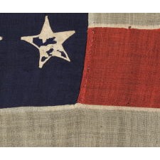 34 STARS ON AN ANTIQUE AMERICAN FLAG MADE DURING THE OPENING YEARS OF THE CIVIL WAR, WITH SPLENDID PRESENTATION RESULTING FROM THE ENDEARING CHARACTERISTICS OF LONG-TERM USE, POSSIBLY FIELD-CARRIED BY A UNION REGIMENT, CA 1861-63, KANSAS STATEHOOD