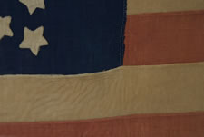 34 STARS, A CIVIL WAR FLAG IN THE "GREAT STAR" OR "GREAT FLOWER" PATTERN, HANDED DOWN THROUGH THE JOHNSON-SCUDDER FAMILY OF OSWEGO COUNTY, WITH VERBAL HISTORY THAT IT WAS CARRIED BY A LOCAL VOLUNTEER UNIT