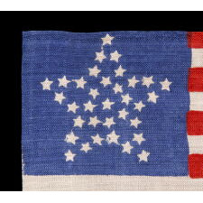 34 STARS IN A "GREAT STAR" PATTERN ON AN ANTIQUE AMERICAN PARADE FLAG WITH A BRILLIANT, ROYAL BLUE CANTON, MADE OF SILK; OPENING TWO YEARS OF THE CIVIL WAR, 1861-63, KANSAS STATEHOOD