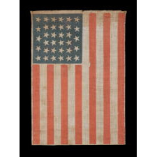 34 STARS, WITH SCATTERED POSITIONING, ON AN ANTIQUE AMERICAN PARADE FLAG MADE DURING THE OPENING TWO YEARS OF THE CIVIL WAR, 1861-63, KANSAS STATEHOOD