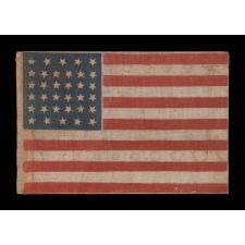 34 STARS, WITH SCATTERED POSITIONING, ON AN ANTIQUE AMERICAN PARADE FLAG MADE DURING THE OPENING TWO YEARS OF THE CIVIL WAR, 1861-63, KANSAS STATEHOOD