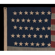 35 STAR ANTIQUE AMERICAN FLAG OF THE CIVIL WAR PERIOD, IN A DESIRABLE SMALL SCALE AMONG ITS COUNTERPARTS, REFLECTS THE TIME DURING WHICH WEST VIRGINIA WAS THE MOST RECENT STATE TO JOIN THE UNION, 1863-1865