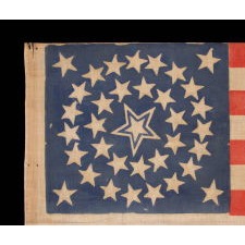 35 STARS IN A MEDALLION CONFIGURATION, ON AN ANTIQUE AMERICAN FLAG OF THE CIVIL WAR PERIOD, WITH A LARGE, HALOED CENTER STAR, 1863-1865, WEST VIRGINIA STATEHOOD