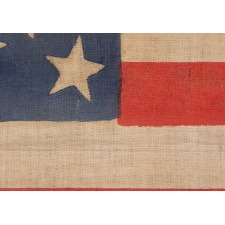 35 STARS IN A MEDALLION CONFIGURATION, ON AN ANTIQUE AMERICAN FLAG OF THE CIVIL WAR PERIOD, WITH A LARGE, HALOED CENTER STAR, 1863-1865, WEST VIRGINIA STATEHOOD