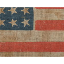 36 STAR ANTIQUE AMERICAN PARADE FLAG OF THE CIVIL WAR ERA, AN ATTRACTIVE EXAMPLE WITH ENDEARING WEAR, NICE COLORS, AND CANTED STARS, 1864-67, NEVADA STATEHOOD