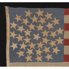 36 STARS ARRANGED IN A RARE "SNOWBALL MEDALLION," ON AN ENTIRELY HAND-SEWN FLAG OF THE CIVIL WAR ERA, WITH GREAT WEAR FROM EXTENDED USE AND IN A GREAT SMALL SIZE FOR THE PERIOD, 1864-1867, NEVADA STATEHOOD