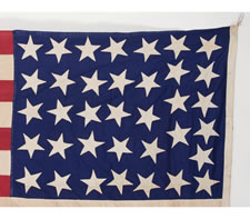 36 STARS ON A BEAUTIFUL GLAZED COTTON CANTON (COTTON CHINTZ), ENTIRELY HAND-SEWN, CIVIL WAR ERA, 1864-1867, IN A GREAT, SMALL SIZE, A HOMEMADE EXAMPLE