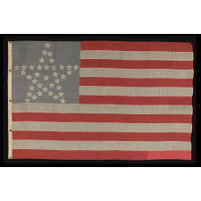 36 STARS IN THE "GREAT STAR" OR "GREAT LUMINARY" PATTERN ON A CIVIL WAR ERA FLAG WITH A DUSTY BLUE CANTON AND A SECTION OF ONE STRIPE SOUVENIRED, 1864-67, NEVADA STATEHOOD