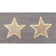 36 STARS IN THE "GREAT STAR" OR "GREAT LUMINARY" PATTERN ON A CIVIL WAR ERA FLAG WITH A DUSTY BLUE CANTON AND A SECTION OF ONE STRIPE SOUVENIRED, 1864-67, NEVADA STATEHOOD