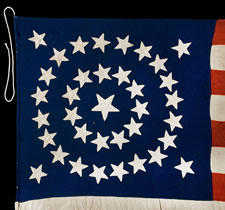 36 STARS IN A MEDALLION CONFIGURATION ON AN ENTIRELY HAND-SEWN FLAG WITH A BEAUTIFULLY ELONGATED FORMAT, CIVIL WAR ERA, 1864-67, NEVADA STATEHOOD