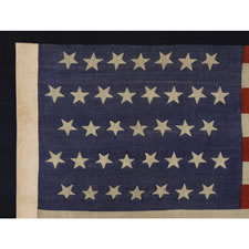 37 DANCING OR TUMBLING STARS ON AN UNUSUAL PRESS-DYED FLAG OF THE 1867-1876 PERIOD, POSSIBLY AND INDIAN WARS-ERA CAMP COLORS, NEBRASKA STATEHOOD