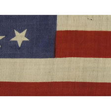 37 DANCING OR TUMBLING STARS ON AN UNUSUAL PRESS-DYED FLAG OF THE 1867-1876 PERIOD, POSSIBLY AND INDIAN WARS-ERA CAMP COLORS, NEBRASKA STATEHOOD