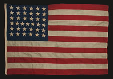 37 HAND-SEWN, SINGLE- APPLIQUED STARS ON A FLAG WITH SMALLER THAN USUAL DIMENSIONS FOR THE PERIOD, 1867-1876, NEBRASKA STATEHOOD