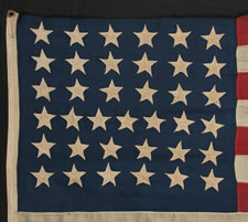 37 HAND-SEWN, SINGLE- APPLIQUED STARS ON A FLAG WITH SMALLER THAN USUAL DIMENSIONS FOR THE PERIOD, 1867-1876, NEBRASKA STATEHOOD