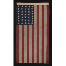 37 STAR ANTIQUE AMERICAN FLAG, ENTIRELY HAND-SEWN AND IN AN ATTRACTIVE, SMALL SCALE FOR THE PERIOD, MADE BY JOSEPH H. FOSTER IN PHILADELPHIA BETWEEN 1867-1876, THE PERIOD WHEN NEBRASKA WAS THE MOST RECENT STATE TO JOIN THE UNION