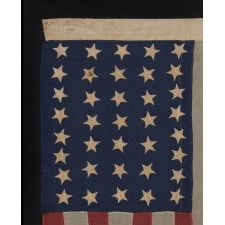 37 STAR ANTIQUE AMERICAN FLAG, ENTIRELY HAND-SEWN AND IN AN ATTRACTIVE, SMALL SCALE FOR THE PERIOD, MADE BY JOSEPH H. FOSTER IN PHILADELPHIA BETWEEN 1867-1876, THE PERIOD WHEN NEBRASKA WAS THE MOST RECENT STATE TO JOIN THE UNION