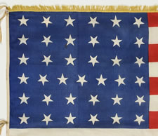 37 STARS, A LARGE PARADE FLAG WITH SILK FRINGE, A HAND-SEWN HOIST, WHIP-STITCHED GROMMETS AND SILK TASSELS, NEBRASKA STATEHOOD, 1867-1876, THE ERA OF AMERICAN RECONSTRUCTION