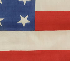 37 STARS, A LARGE PARADE FLAG WITH SILK FRINGE, A HAND-SEWN HOIST, WHIP-STITCHED GROMMETS AND SILK TASSELS, NEBRASKA STATEHOOD, 1867-1876, THE ERA OF AMERICAN RECONSTRUCTION