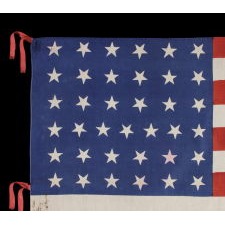 37 STARS ON A LARGE SCALE SILK PARADE FLAG WITH HAND-INSCRIBED MOURNING NOTATION REGARDING THE 1880 DEATH OF PRESIDENT JAMES GARFIELD AND ITS STARS ARRANGED IN A "DANCING" OR "TUMBLING" ORIENTATION, NEBRASKA STATEHOOD, 1867-1876, THE ERA OF AMERICAN RECONSTRUCTION