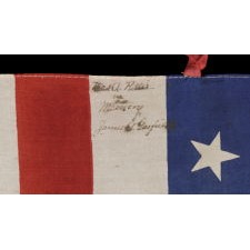 37 STARS ON A LARGE SCALE SILK PARADE FLAG WITH HAND-INSCRIBED MOURNING NOTATION REGARDING THE 1880 DEATH OF PRESIDENT JAMES GARFIELD AND ITS STARS ARRANGED IN A "DANCING" OR "TUMBLING" ORIENTATION, NEBRASKA STATEHOOD, 1867-1876, THE ERA OF AMERICAN RECONSTRUCTION