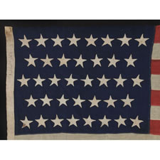 38 HAND-SEWN STARS ON AN ANTIQUE FLAG IN A SMALL SCALE FOR THE 19TH CENTURY, SIGNED ALBANY, NEW YORK, 1876-1889, COLORADO STATEHOOD