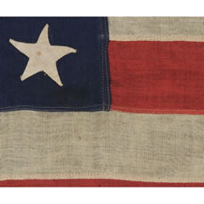 38 HAND-SEWN STARS ON AN ANTIQUE FLAG IN A SMALL SCALE FOR THE 19TH CENTURY, SIGNED ALBANY, NEW YORK, 1876-1889, COLORADO STATEHOOD