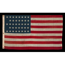 38 STAR ANTIQUE AMERICAN FLAG WITH A NOTCHED CONFIGURATION, MADE BY THE U.S. BUNTING COMPANY IN LOWELL, MASSACHUSETTS, REFLECTS THE ERA OF COLORADO STATEHOOD, circa 1876-1889