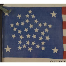 38 STAR ANTIQUE FLAG WITH A RARE AND BEAUTIFUL VARIATION OF THE "GREAT STAR" OR "GREAT LUMINARY" PATTERN, AN EXAMPLE OF EXTRAORDINARY QUALITY, MADE BY R.W. MUSGROVE IN BRISTOL, NEW HAMPSHIRE FOR AN 1885 REUNION OF THE 12th NH VOLUNTEERS