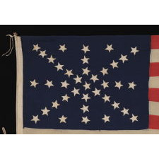 38 STARS ON AN ENTIRELY HAND-SEWN FLAG WITH A DYNAMIC STARBURST CROSS, ONE OF THE MOST RARE & VISUALLY SPECTACULAR CONFIGURATIONS IN FLAG COLLECTING; ONCE BELONGING TO IRA SWARTZ OF PENNSYLVANIA, A CAREER SOLDIER WHO SERVED WITH THE FAMED 1ST MICHIGAN CAVALRY DURING THE CIVIL WAR; MADE CA 1876-1889