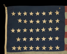 38 STARS IN A NOTCHED CONFIGURATION, ENTIRELY HAND-SEWN, MADE BY WILLIAM J. POWELL IN NEW YORK CITY BETWEEN 1881 AND 1885, (COLORADO STATEHOOD)