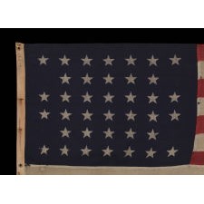 38 STARS IN A NOTCHED, CROSSHATCH PATTERN ON AN ANTIQUE AMERICAN FLAG MADE BY THE U.S. BUNTING COMPANY IN LOWELL, MASSACHUSETTS, 1876-1889, COLORADO STATEHOOD