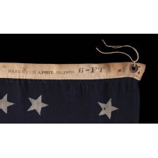 38 STARS IN A NOTCHED, CROSSHATCH PATTERN ON AN ANTIQUE AMERICAN FLAG MADE BY THE U.S. BUNTING COMPANY IN LOWELL, MASSACHUSETTS, SIGNED "TORREY," REFLECTS THE ERA OF COLORADO STATEHOOD, CIRCA 1876-1889