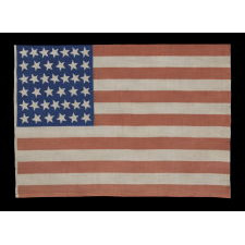 39 CANTED STARS ON AN ANTIQUE AMERICAN FLAG DATING TO THE 1876 CENTENNIAL, NEVER AN OFFICIAL STAR COUNT, REFLECTS THE ANTICIPATED ARRIVAL OF THE DAKOTA TERRITORY