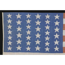 39 STAR ANTIQUE AMERICAN FLAG WITH AN ELONGATED FORMAT AND TWO SIZES OF STARS IN ALTERNATING COLUMNS, NEVER AN OFFICIAL STAR COUNT, 1876