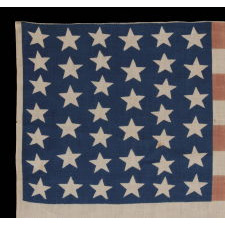 39 STARS IN TWO SIZES, ALTERNATING FROM ONE COLUMN TO THE NEXT, ON AN ANTIQUE AMERICAN PARADE FLAG DATING TO THE 1876 CENTENNIAL, NEVER AN OFFICIAL STAR COUNT, REFLECTS THE ANTICIPATED ARRIVAL OF THE DAKOTA TERRITORY