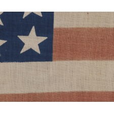 39 STARS IN TWO SIZES, ALTERNATING FROM ONE COLUMN TO THE NEXT, ON AN ANTIQUE AMERICAN PARADE FLAG DATING TO THE 1876 CENTENNIAL, NEVER AN OFFICIAL STAR COUNT, REFLECTS THE ANTICIPATED ARRIVAL OF COLORADO AND THE DAKOTA TERRITORY