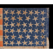 40 STAR ANTIQUE AMERICAN FLAG, AN EXTREMELY RARE COUNT REFLECTING THE ADDITION OF SOUTH & NORTH DAKOTA ON NOVEMBER 2ND, 1889, ACCURATE FOR JUST 6 DAYS; WITH OVERPRINTED ADVERTISING FOR A CIVIL WAR VERTERN’S UNIT IN GEORGETOWN, MASSACHUSETTS; ILLUSTRATED IN “THE STARS & STRIPES: FABRIC OF THE AMERICAN SPIRIT” by RICHARD PIERCE (2005); EXHIBITED AT THE MUSEUM OF THE AMERICAN REVOLUTION FROM JUNE – SEPTEMBER, 2021