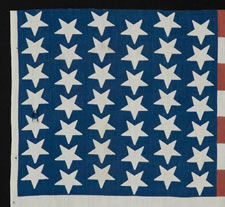 42 UPSIDE-DOWN STARS IN A WAVE CONFIGURATION ON A BRILLIANT BLUE CANTON, 1889-1890, WASHINGTON STATEHOOD, AN UNOFFICIAL STAR COUNT