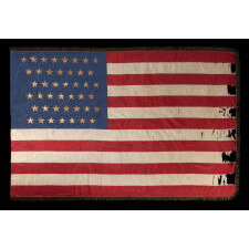 43 GILT-PAINTED STARS ON A SILK, ANTIQUE AMERICAN FLAG WITH BULLION FRINGE; REFLECTS THE ADDITION OF IDAHO AS THE 43RD STATE ON JULY 3RD, 1890, ONE OF THE RAREST STAR COUNTS AMONG SURVIVING AMERICAN FLAGS OF THE 19TH CENTURY