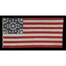 43 STAR ANTIQUE AMERICAN FLAG REFLECTING IDAHO STATEHOOD, ONE OF THE RAREST STAR COUNTS AMONG SURVIVING AMERICAN FLAGS OF THE 19TH CENTURY; A MASTERPIECE OF EARLY FLAG-MAKING WITH AN EXCEPTIONAL STARBURST MEDALLION CONFIGURATION, CIRCA 1890