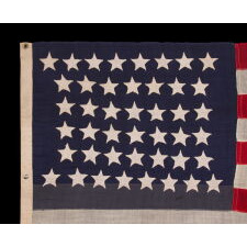 44 STAR ANTIQUE AMERICAN FLAG WITH AN HOURGLASS ARRANGEMENT ON A TWO-TONE BLUE CANTON; REFLECTS THE ERA WHEN WYOMING WAS THE MOST RECENT STATE TO JOIN THE UNION, 1890-1896