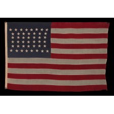 44 STAR FLAG WITH BEAUTIFULLY HAND-SEWN STARS IN AN HOURGLASS PATTERN ON A SOLDIER BLUE CANTON, AN ANTIQUE EXAMPLE; REFLECTS THE ADDITION OF WYOMING 1890-1896