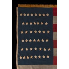 44 STARS ON AN ANTIQUE AMERICAN FLAG WITH AN EXAGGERATEDLY TALL AND NARROW CANTON, ON A U.S. ARMY REGULATION BATTLE FLAG MADE DURING THE LATE INDIAN WARS PERIOD, REFLECTS THE RECENT ADDITION OF WYOMING TO THE UNION, 1890-1896