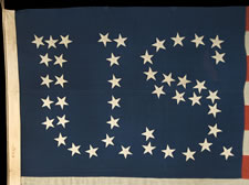 44 STARS CONFIGURED INTO THE LETTERS "U.S.", PATENTED IN 1890 BY W.R. WASHBURN, ONE OF ONLY FOUR KNOWN SURVIVING EXAMPLES AND ONE OF THE BOLDEST DESIGNS KNOWN TO EXIST IN EARLY FLAGS