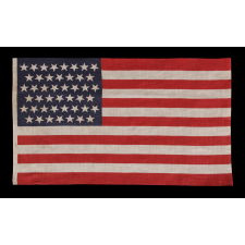 45 STARS IN LINEAR ROWS, WITH “DANCING” OR “TUMBLING” ORIENTATION, ON AN ANTIQUE AMERICAN PARADE FLAG, 1896-1908, SPANISH-AMERICAN WAR ERA, REFLECTS UTAH STATEHOOD