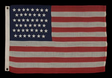 45 STARS ON THE SMALLEST PIECED-AND-SEWN, WOOL BUNTING, COMMERCIALLY MANUFACTURED FLAG THAT I HAVE EVER ENCOUNTERED, FLOWN AT AN INN IN OREGON DURING THE PATRIOTISM THAT SURROUNDED THE SPANISH-AMERICAN WAR, 1896-1908, UTAH STATEHOOD