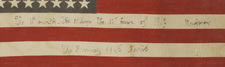 48 STAR AMERICAN PARADE FLAG WITH HAND-WRITTEN INSCRIPTIONS COMMEMORATING THE END OF WWI AND WWII IN NEW YORK AND PARIS