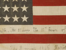 48 STAR AMERICAN PARADE FLAG WITH HAND-WRITTEN INSCRIPTIONS COMMEMORATING THE END OF WWI AND WWII IN NEW YORK AND PARIS