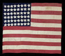 48 STAR FLAG, CANTON RESTING ON THE WAR STRIPE, MADE IN FRANCE DURING WWII TO WELCOME U.S. TROOPS INTO EPINAL IN 1944, FOLLOWING LIBERATION